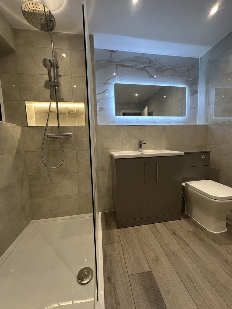 Finished walk-in shower and vanity by Andrade Renovations